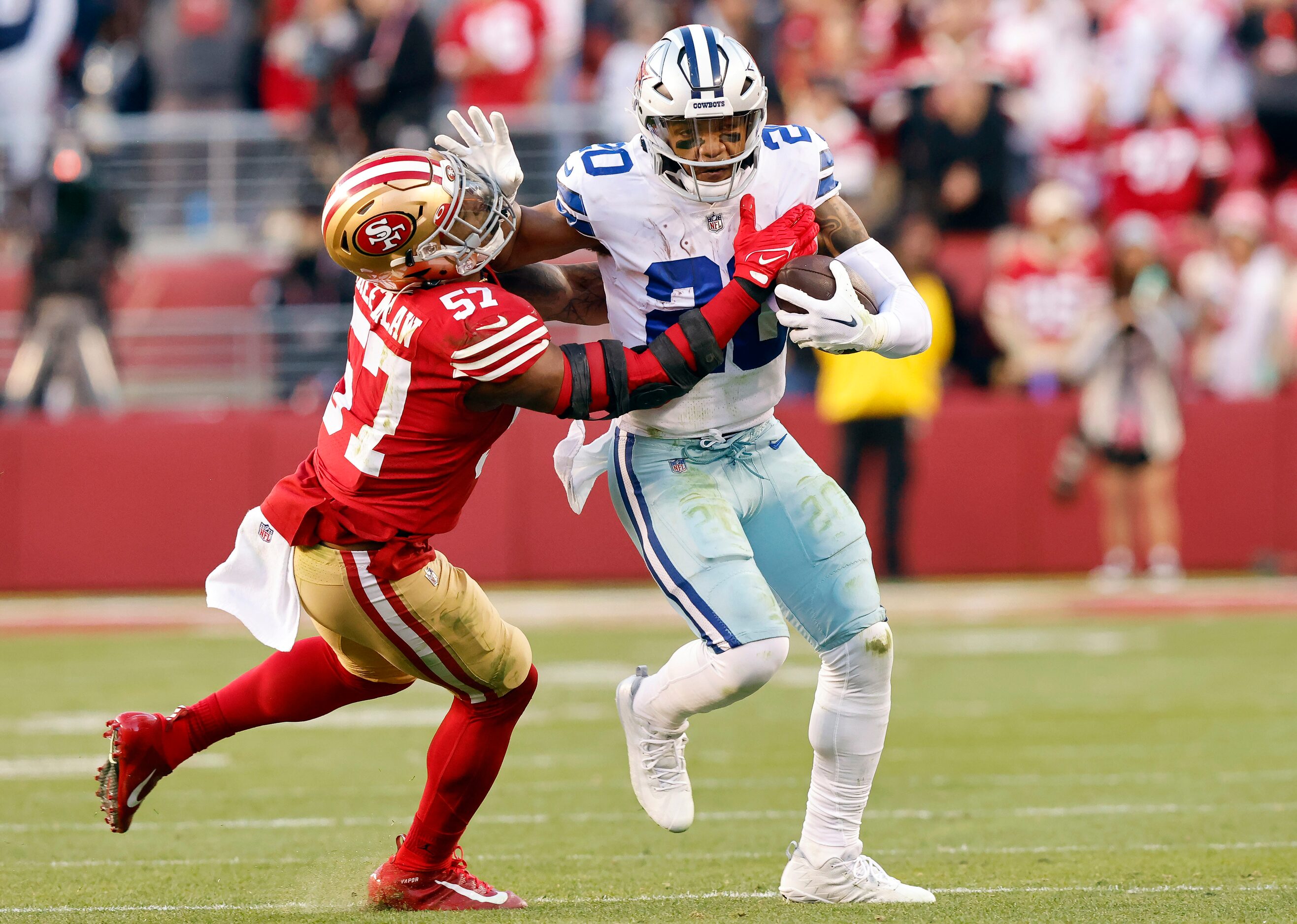 Dallas Cowboys running back Tony Pollard (20) pushes off San Francisco 49ers linebacker Dre...