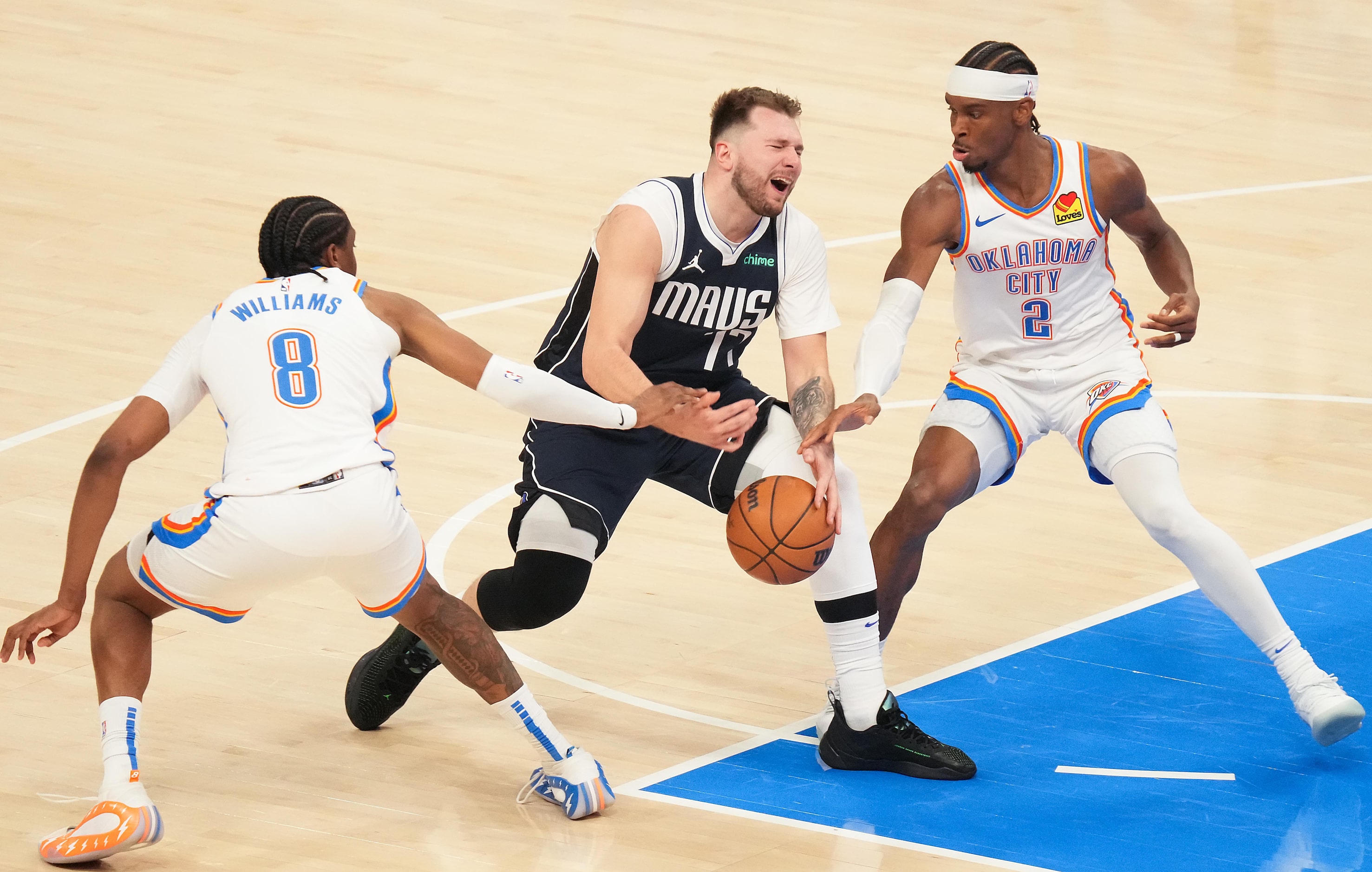 Dallas Mavericks guard Luka Doncic (77) loses the ball as he tries to drive between Oklahoma...