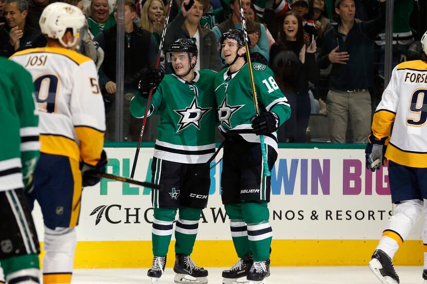 Dallas Stars' Julius Honka (6), left, celebrates with Tyler Pitlick (18), after Pitlick...