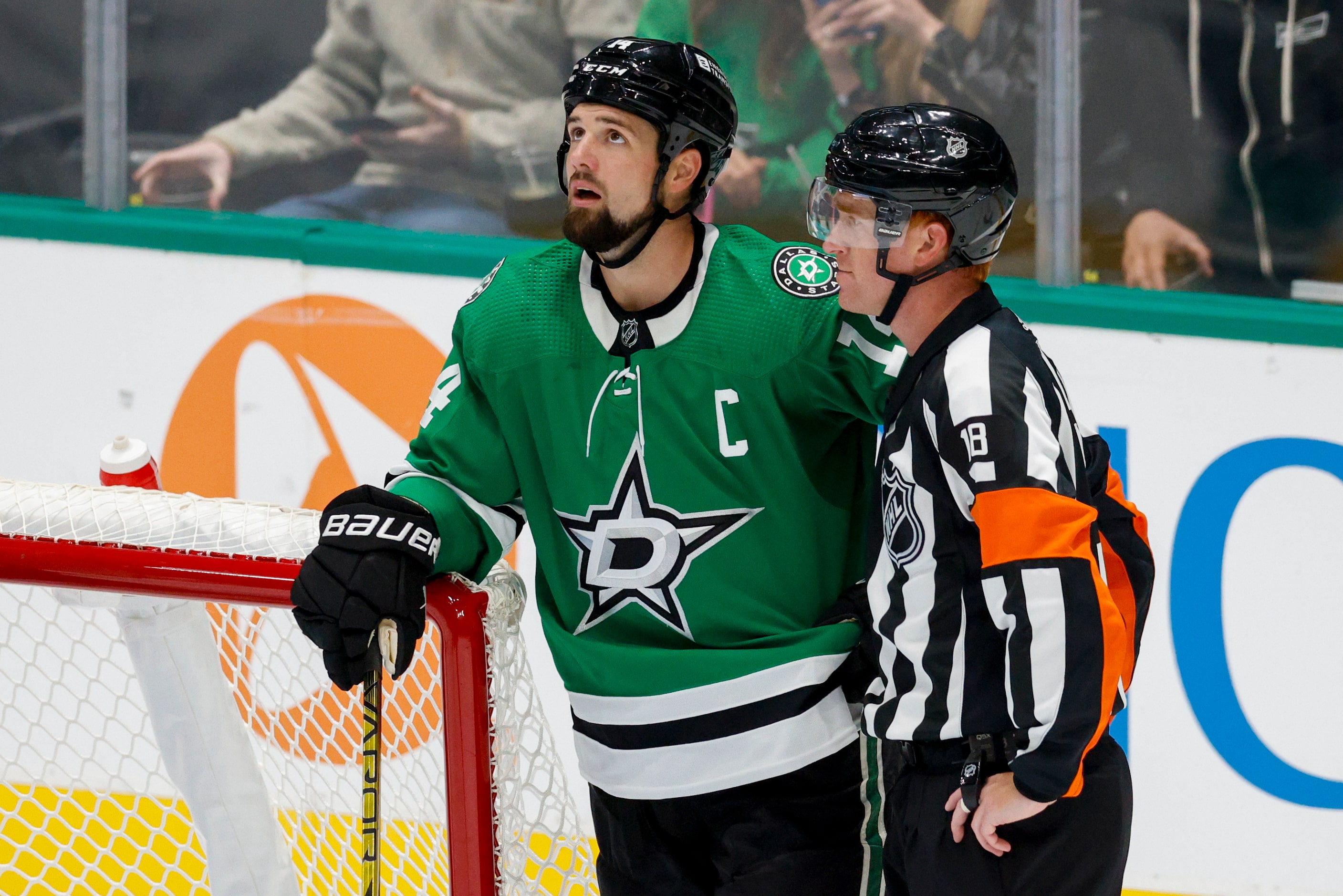 Dallas Stars left wing Jamie Benn (14) watches a replay alongside an official during the...