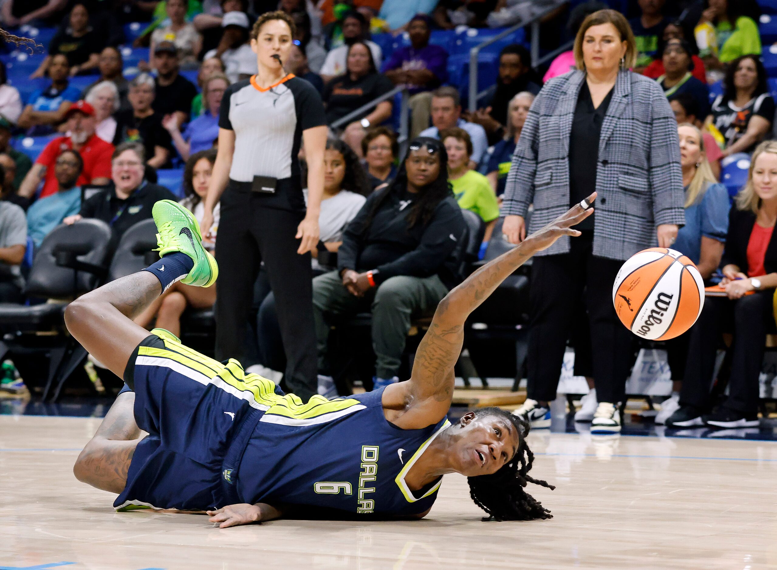 Dallas Wings forward Natasha Howard (6) riches for the ball after she lost control against...