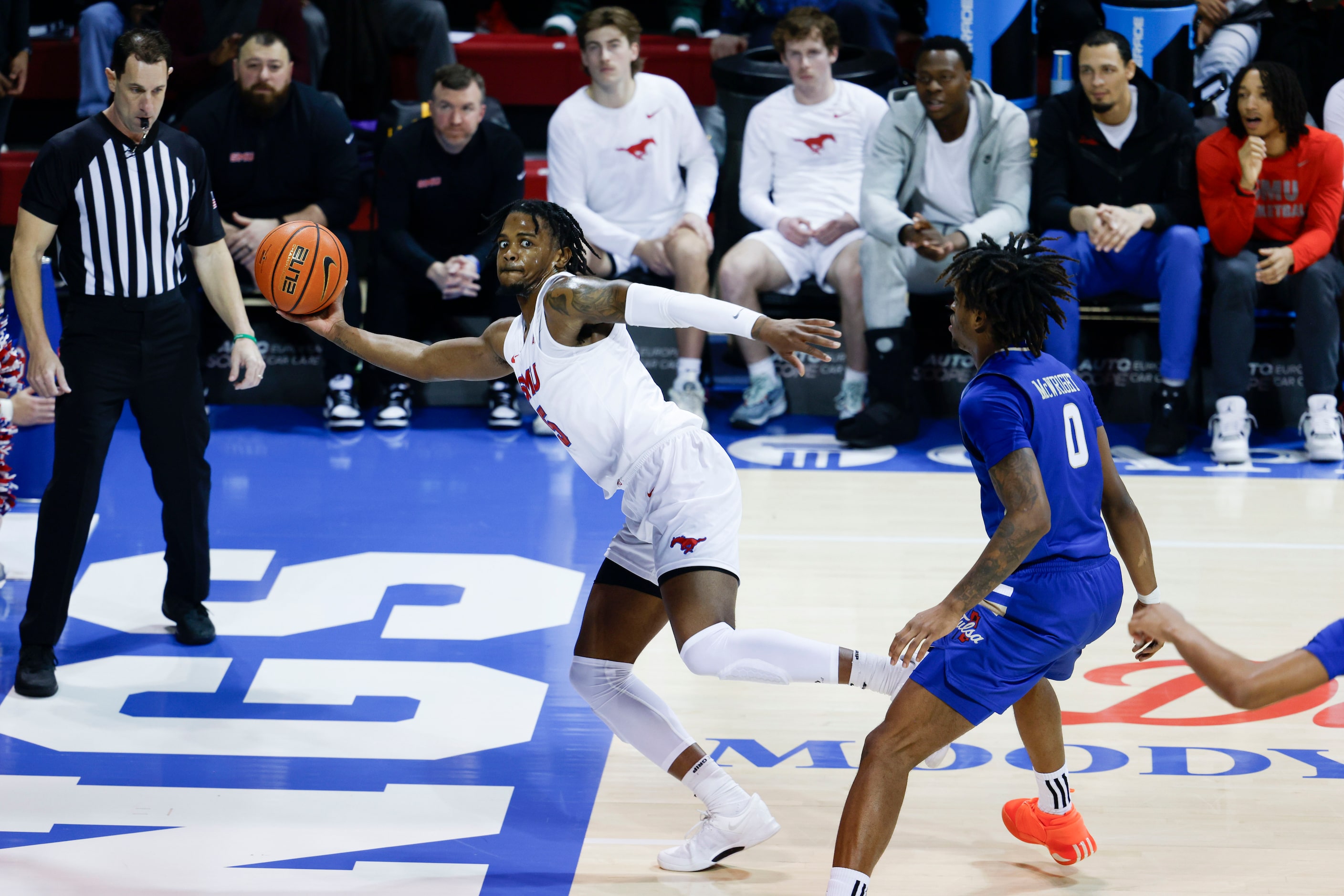 Southern Methodist guard Ricardo Wright (left) reaches out to save an outbound ball past...