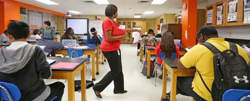 
Science teacher Willisa House returns classwork to her students at Elsie Robertson Middle...