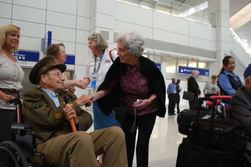 
Printis Sibley is greeted by Colleen Hager as a group of military veterans embarks on a...