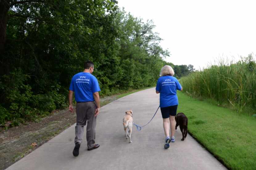 Kathy Latinis walks her two pooches, Lilly and Harley, with Michael Walenciak on the Watters...