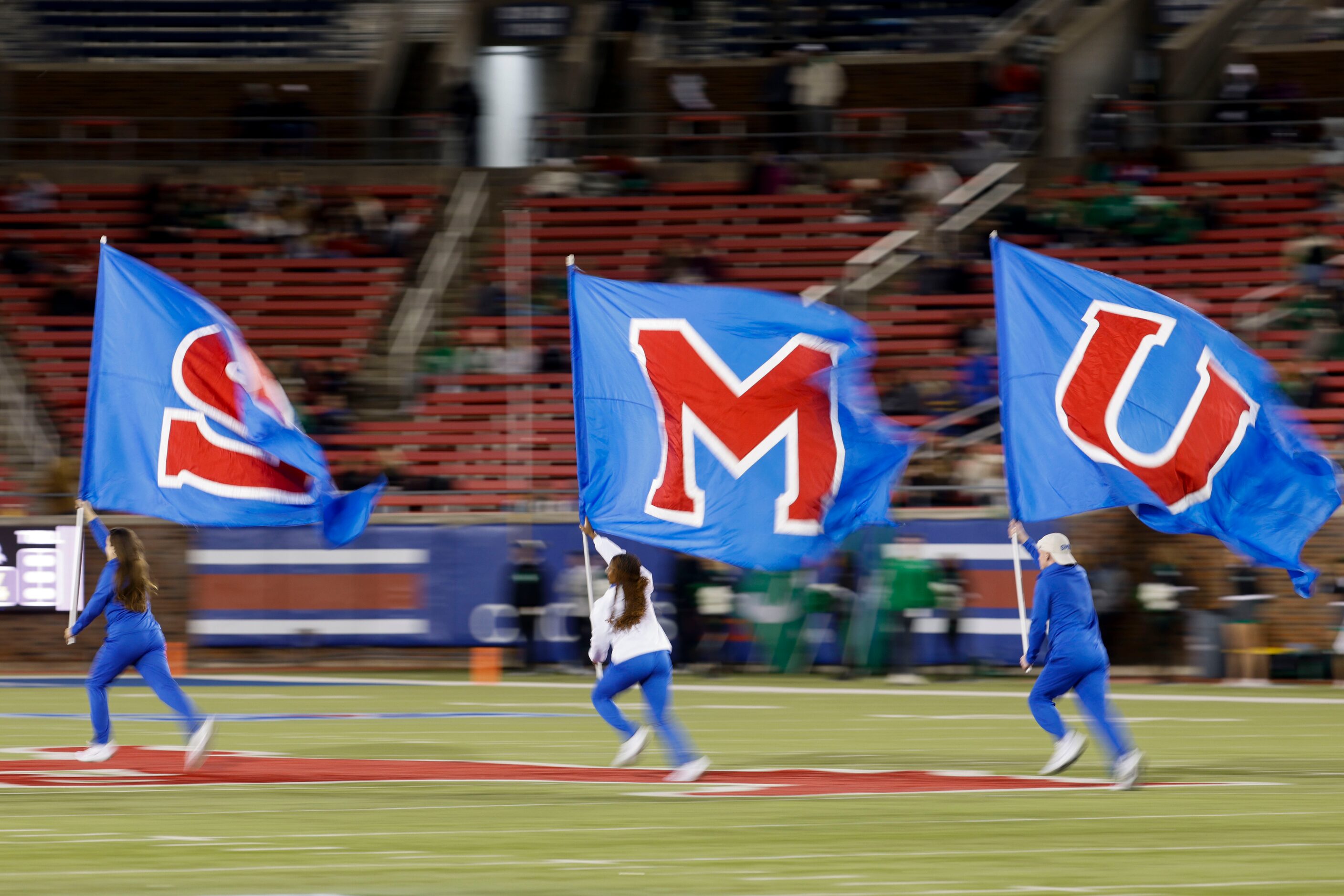 SMU flag runs on the field against UNT during the second half of a football game at Gerald...