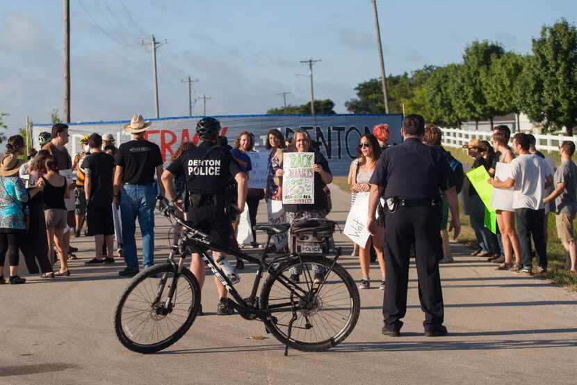 
Denton police officers block a group protesting hydraulic fracturing in June. Photo by...