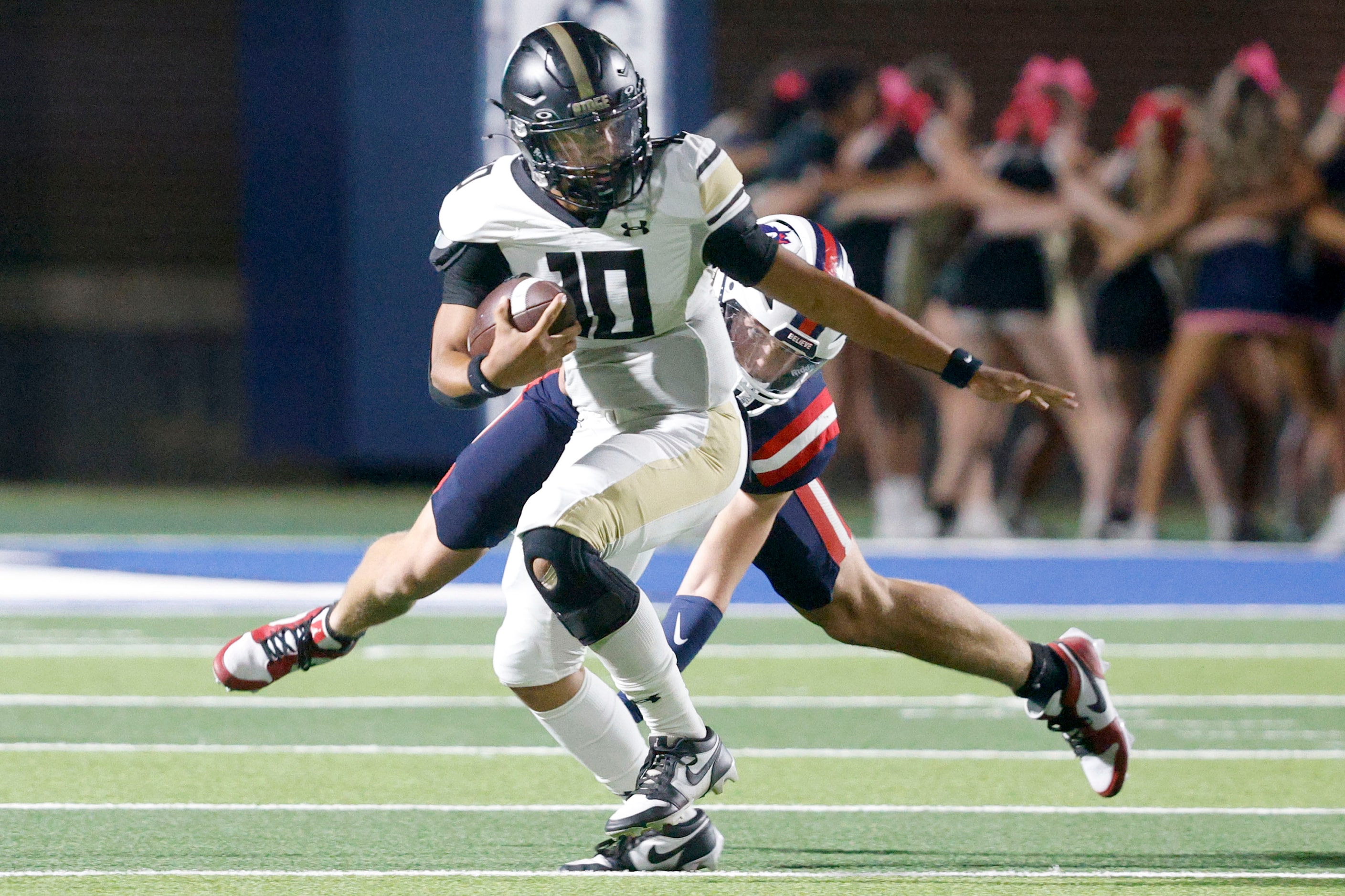 Fossil Ridge's quarterback Malaki Lockhart (10) is tackled by Richland's Gage Goodwin (43)...