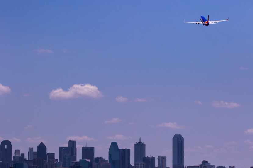 A Southwest Airlines 737 flew over the downtown skyline on takeoff from Dallas Love Field on...