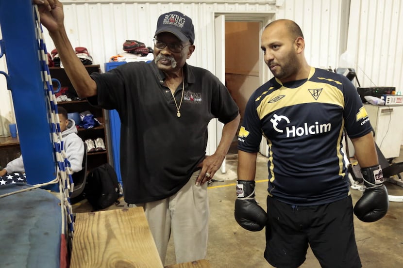 Curtis Cokes. 76, as former boxing champion from Dallas, Texas, talks to boxer Alberto Baez,...