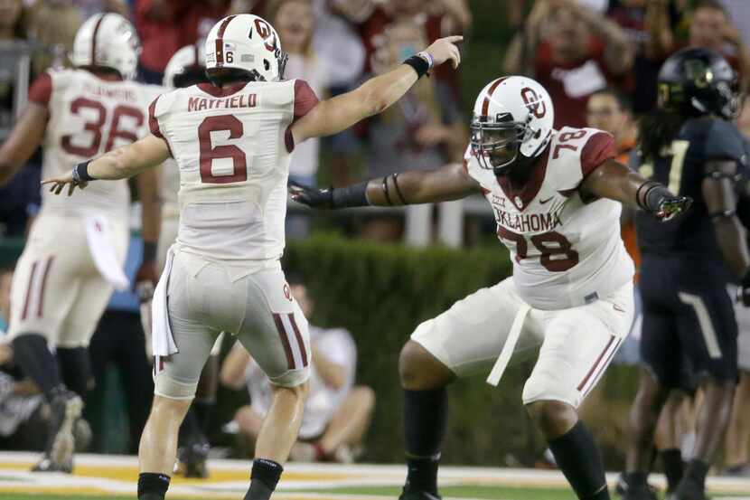 Oklahoma quarterback Baker Mayfield (6) celebrates a touchdown with teammate offensive...