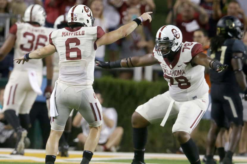 Oklahoma quarterback Baker Mayfield (6) celebrates a touchdown with teammate offensive...