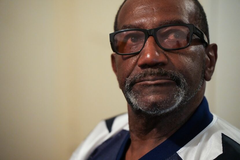 Sweat glistens on his face as Roy Dunn sits in the room he rents on Tuesday, Aug. 22, 2023,...