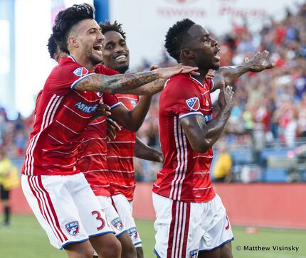 Maxi Urruti and Atiba Harris celebrate with Maynor Figueroa against the Houston Dynamo