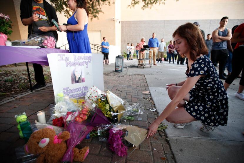 Rosie Atkinson leaves flowers during a memorial held for Janeera Gonzalez, the North Lake...