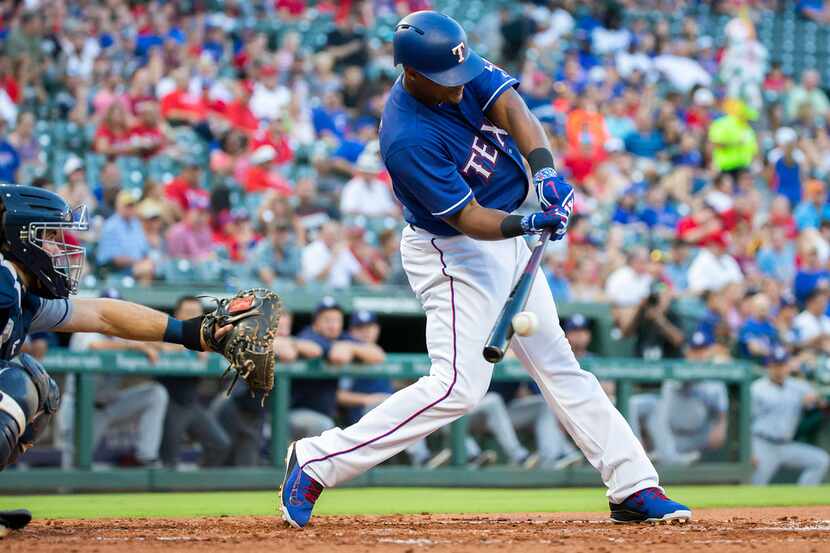 Texas Rangers designated hitter Adrian Beltre drives in shortstop Elvis Andrus with a double...