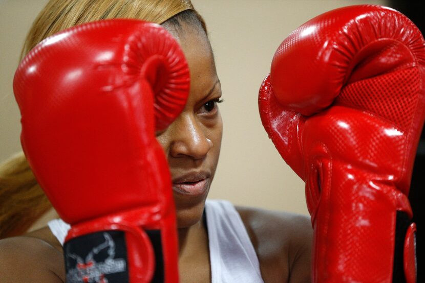 Tracy Dennard hits the bag during workout at I Love Kickboxing gym in Richardson. 