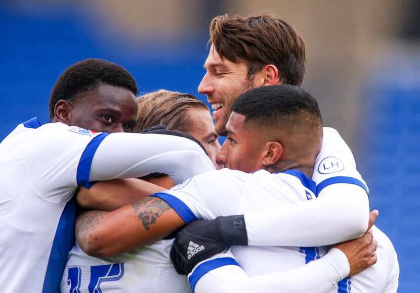 FC Dallas players embrace their teammate midfielder Jacori Hayes (15) after scoring a goal...