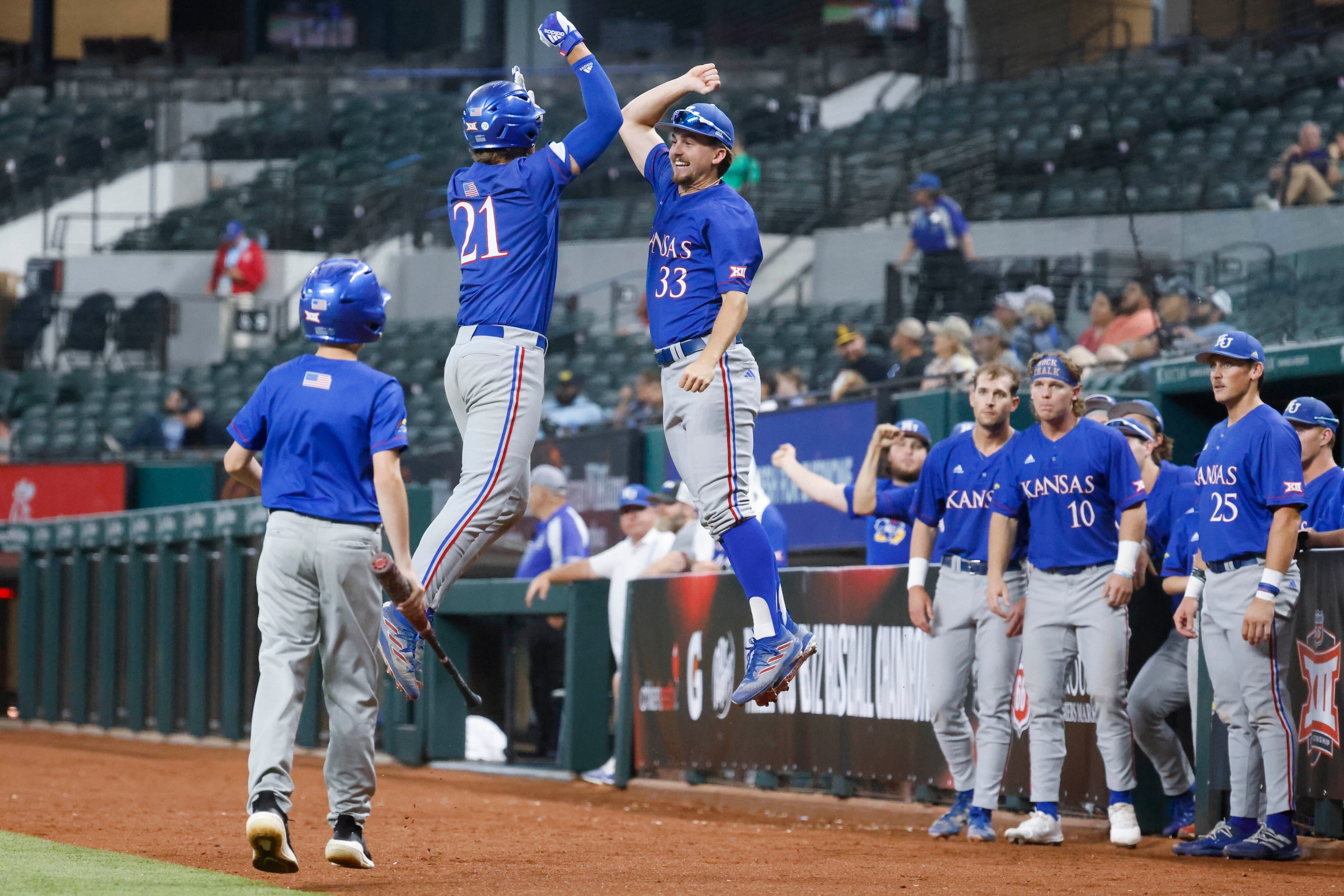 Kansas catcher Jake English (21) and utility Sam Hunt (33) cheers after a homer by English...