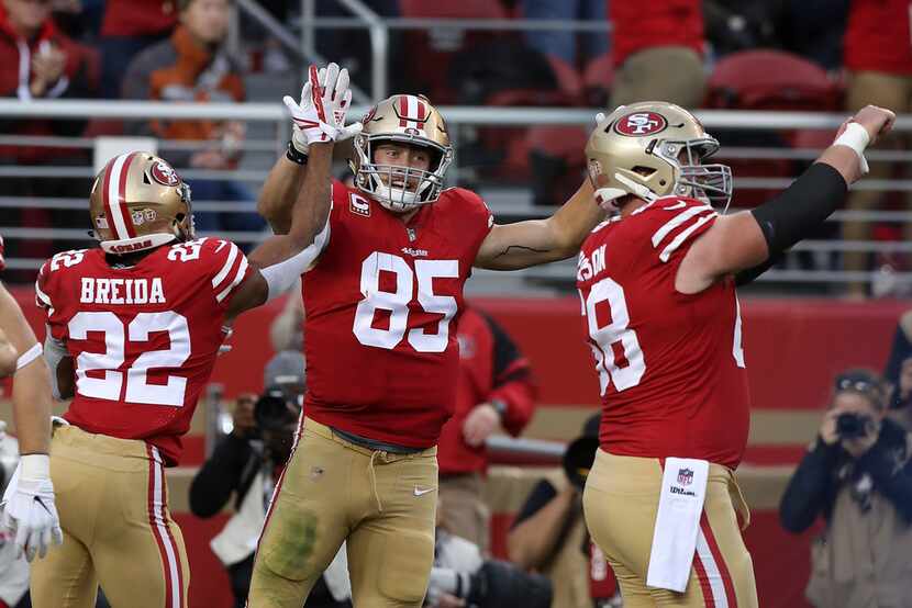 George Kittle (85) of the San Francisco 49ers celebrates a touchdown with teammates during...