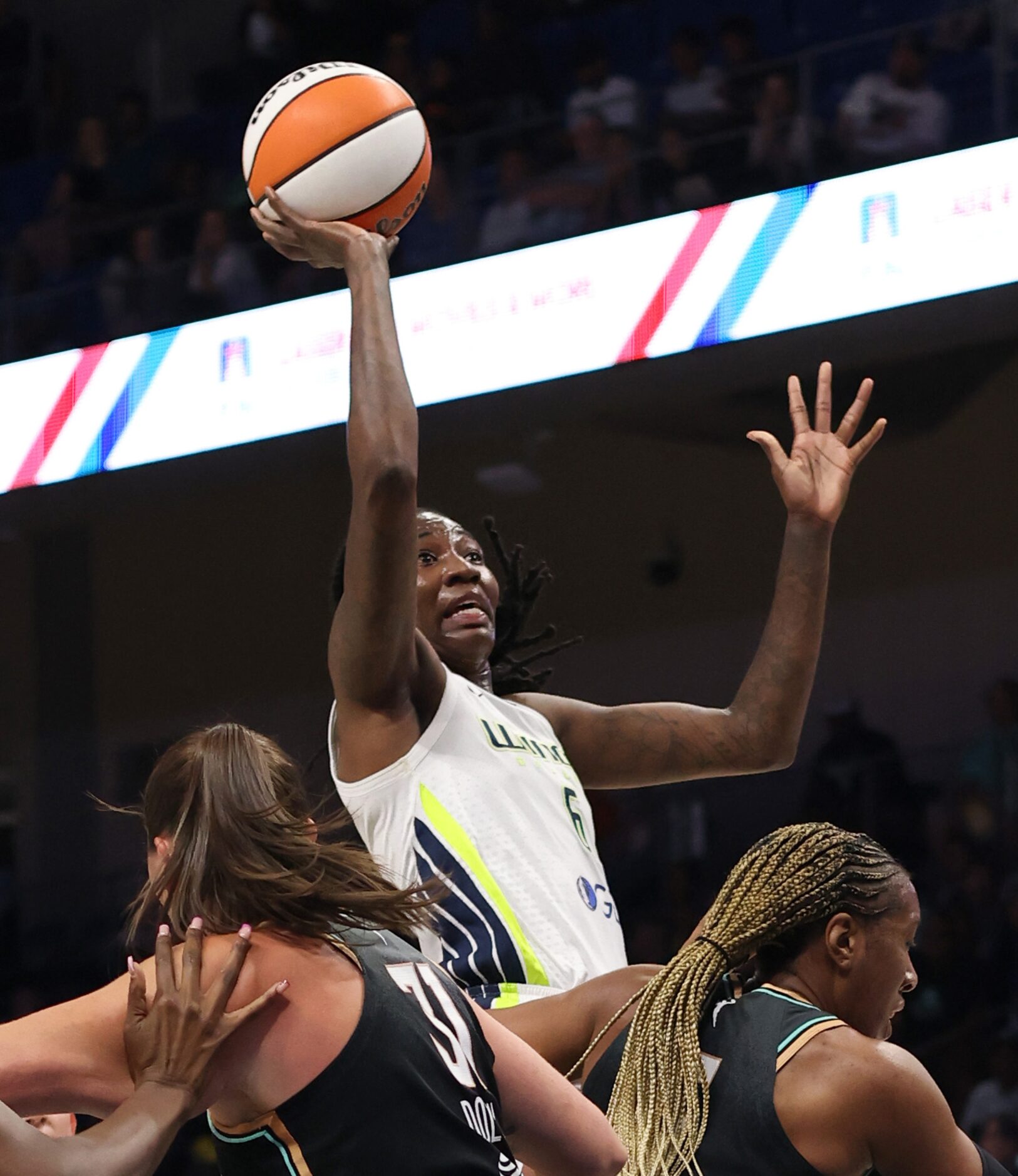 Dallas Wings forward Natasha Howard (6) shoots over a pair of New York Liberty players...