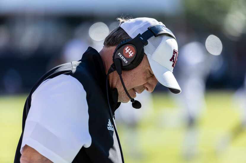 FILE - Texas A&M head coach Jimbo Fisher looks down between plays during an NCAA football...