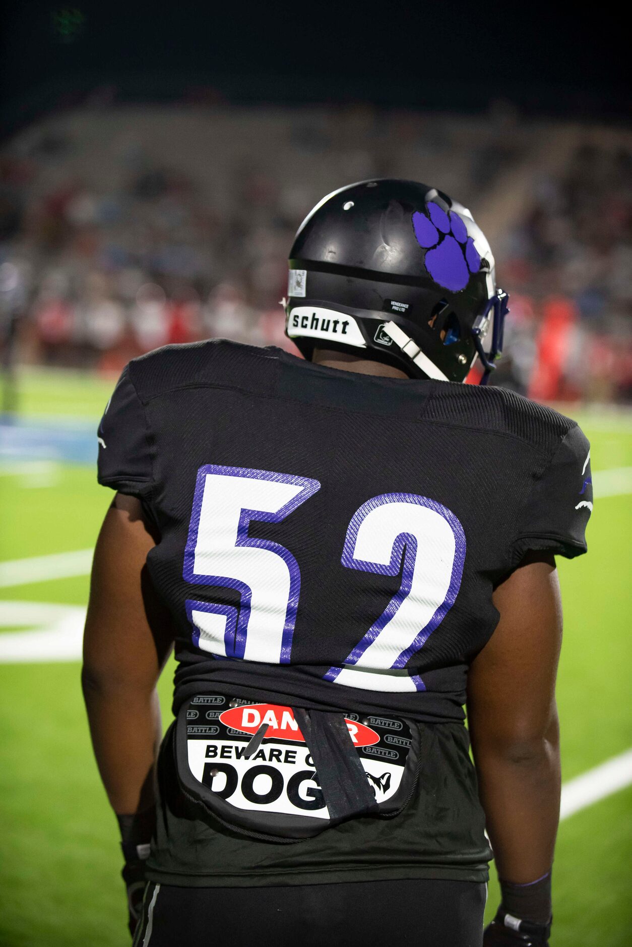 Lincoln senior Jayden Blevins (52) watches the game from the sideline during a high school...