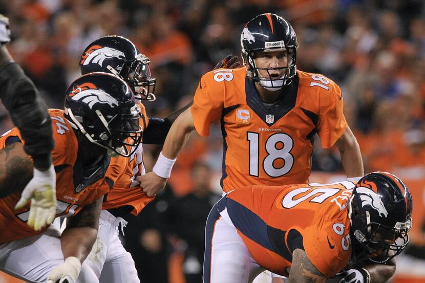 FILE - In this Sept. 23, 2013, file photo, Denver Broncos quarterback Peyton Manning (18)...