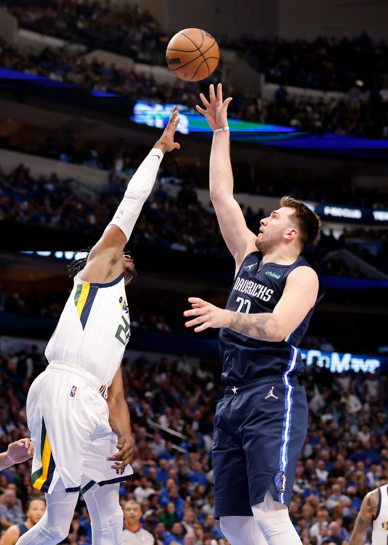 Dallas Mavericks guard Luka Doncic (77) flows a shot over Utah Jazz forward Danuel House Jr....