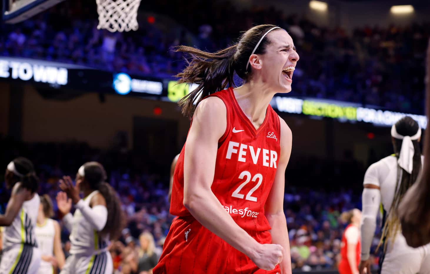 Indiana Fever guard Caitlin Clark (22) reacts after drawing a foul on a driving lay up...
