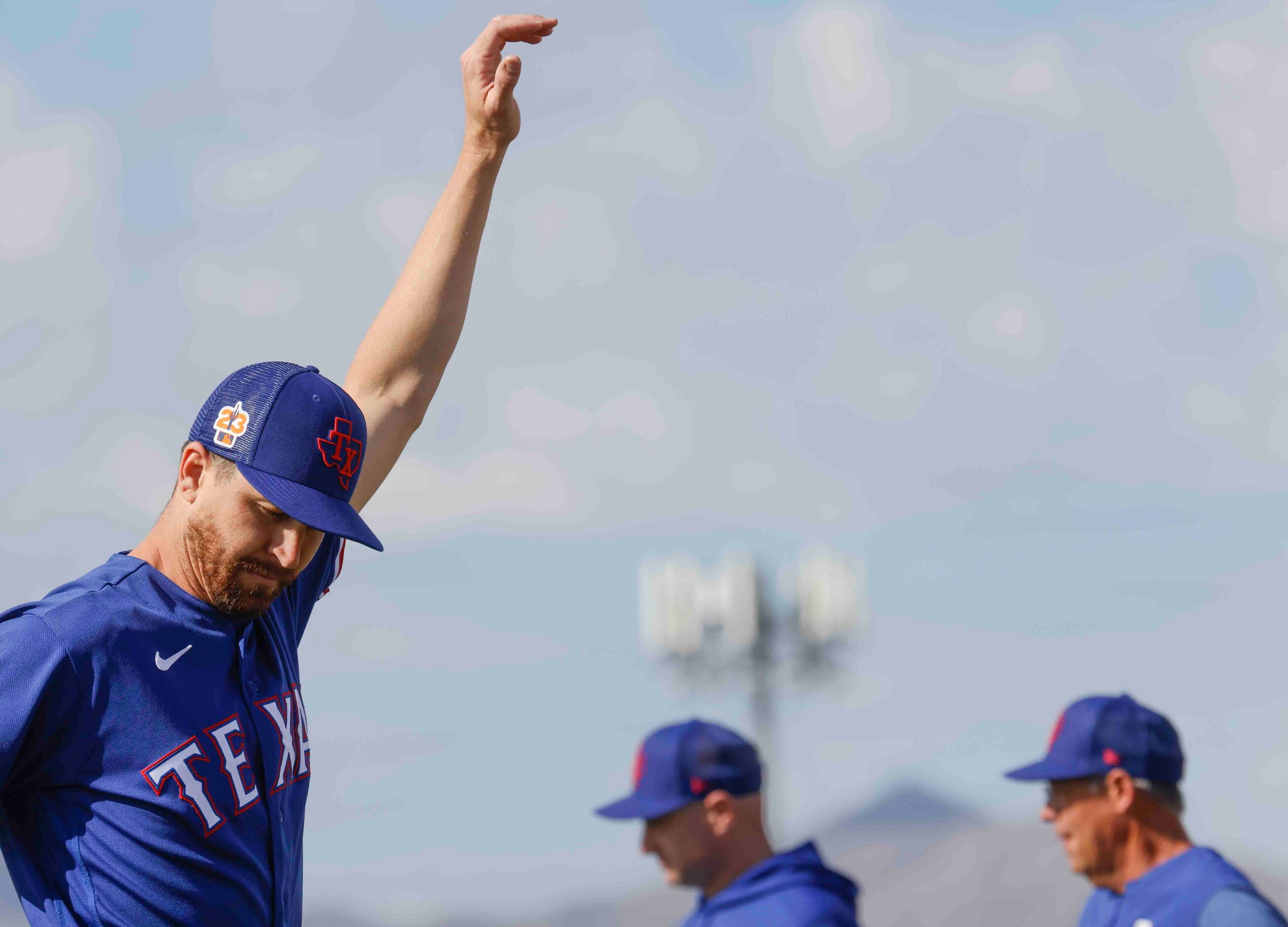 Texas Rangers pitcher Jacob deGrom stretches during a spring training workout at the team's...