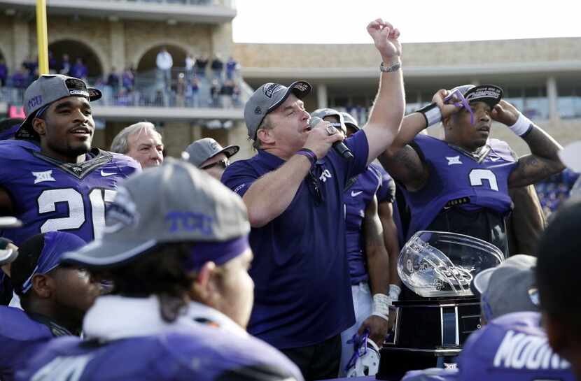 FILE - TCU head coach Gary Patterson congratulates fans during a trophy presentation after...