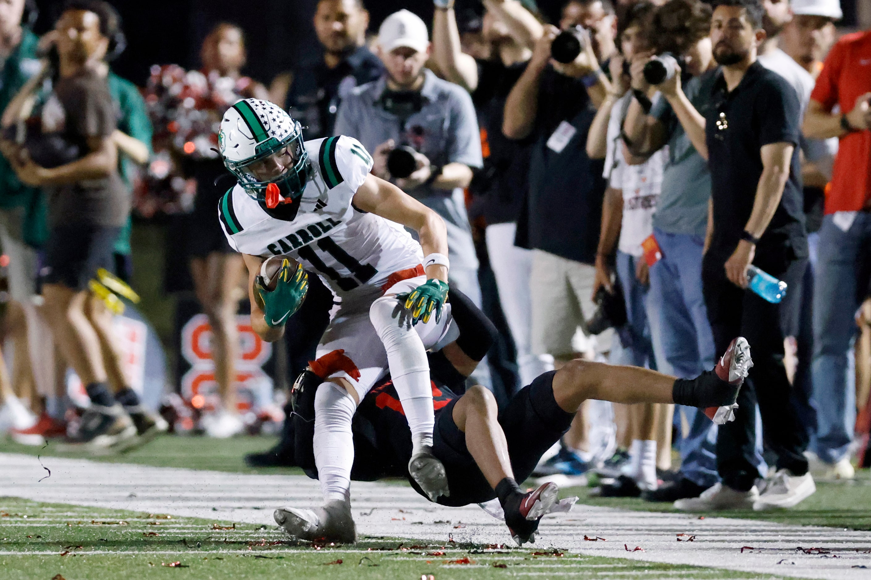 Euless Trinity defensive back Lemariea Parson (12) tackles Southlake Carroll wide receiver...