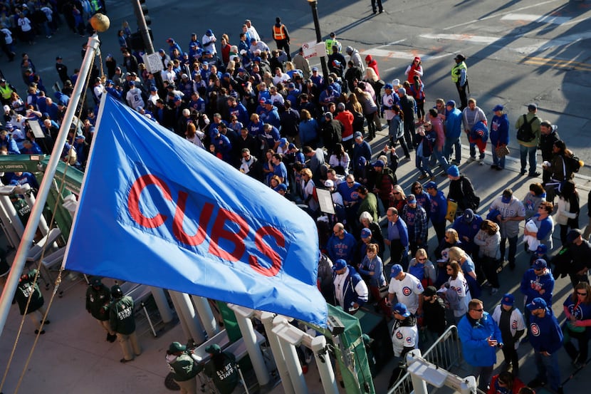Fans wait outside Wrigley Field before Game 6 of the National League baseball championship...