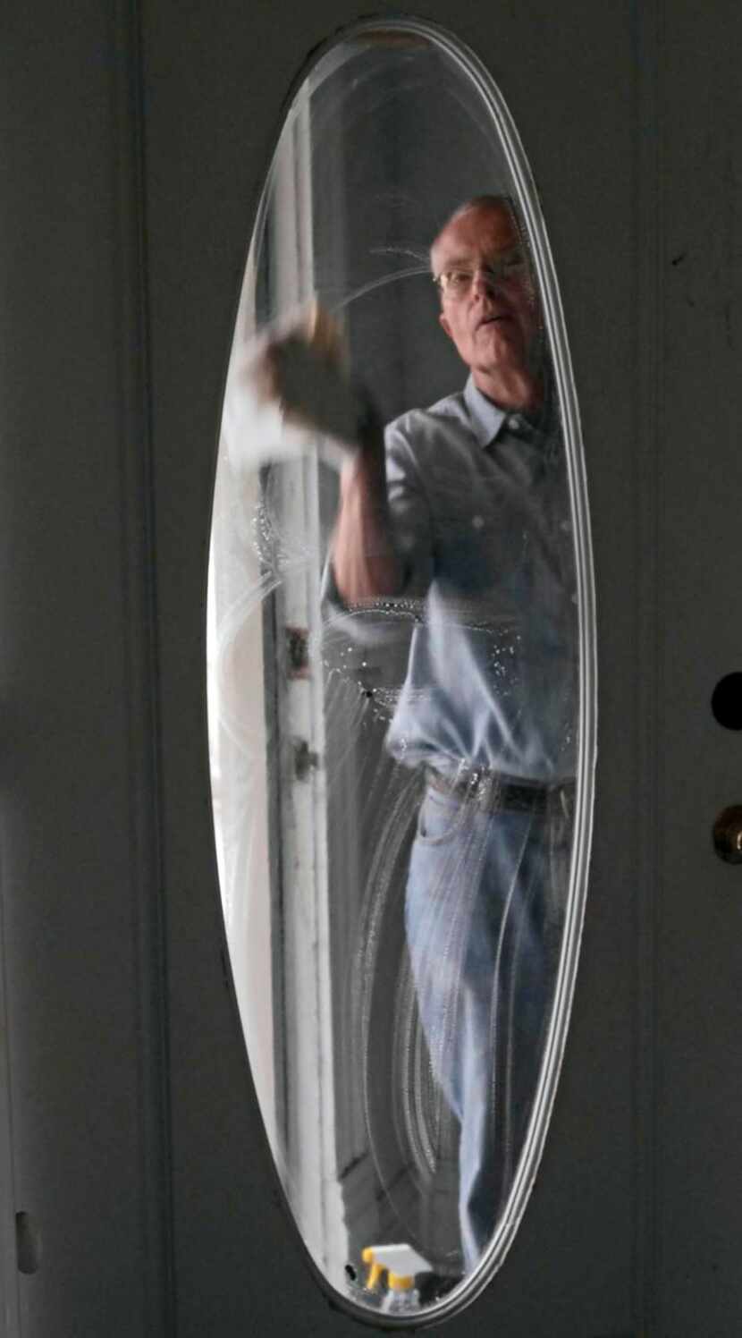 
Louis Moore cleans the front door of the Pace House. Moore and his wife, Kay, have restored...