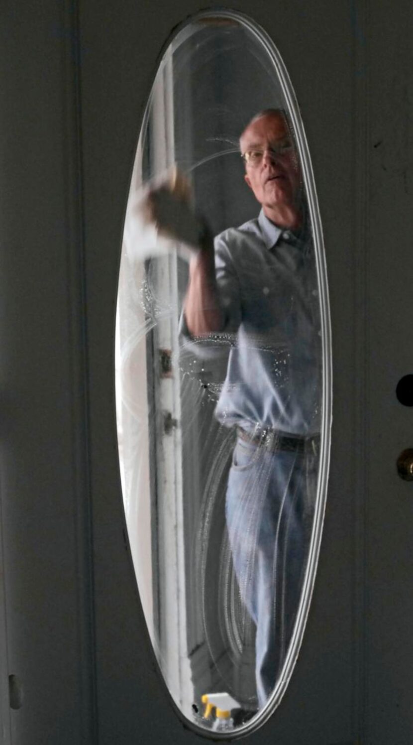 
Louis Moore cleans the front door of the Pace House. Moore and his wife, Kay, have restored...