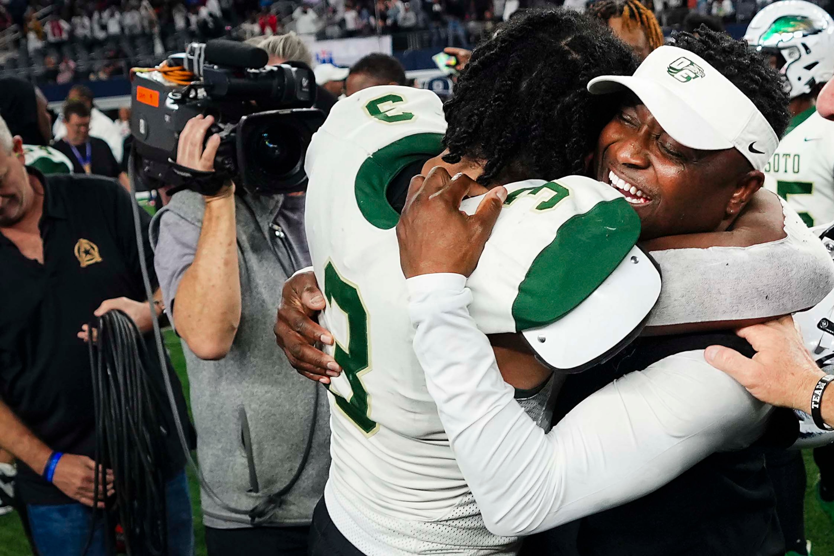 DeSoto head coach Claude Mathis hugs linebacker Brandon Booker after a victory over Humble...