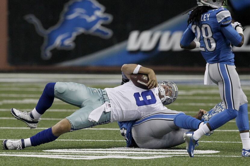 Dallas Cowboys quarterback Tony Romo (9) is twisted up after pressure against the Dallas...