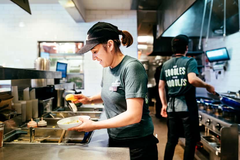 A Noodles & Company team member preps food at a Denver-area restaurant. 