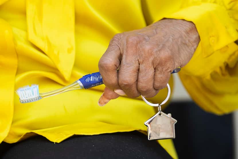 Opal Lee, the Grandmother of Juneteenth, sits and listens as she holds her key and a...