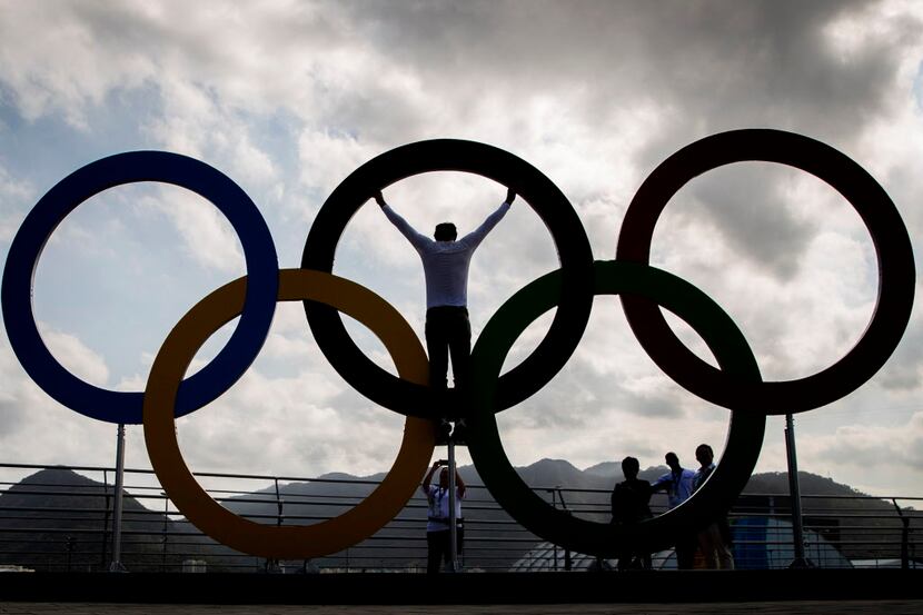 Gesser Galvao Sales of Rio de Janeiro poses in a set of Olympic rings in the Olympic Park on...