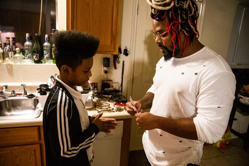 Dorelle Harrison teaches his son, Prince Harrison, how to use chopsticks in his Dallas home...