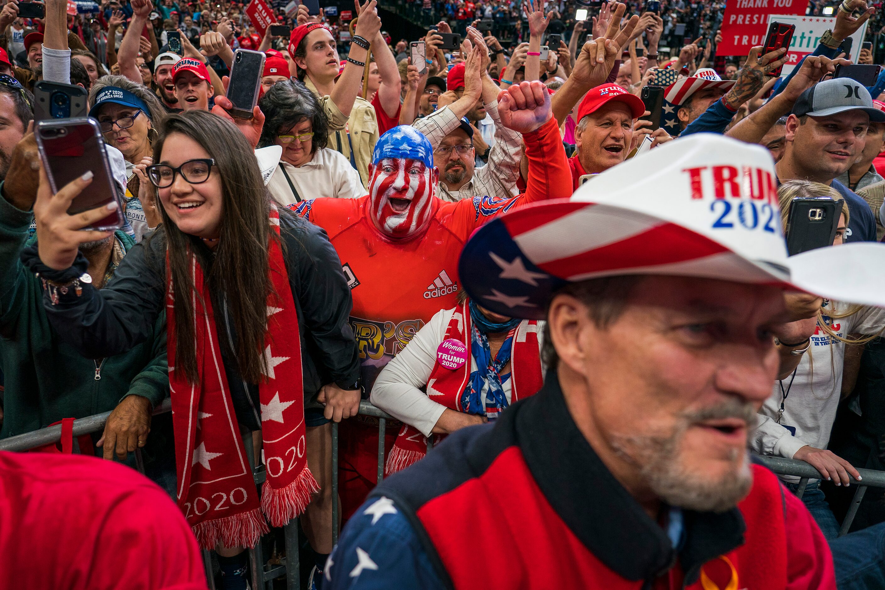 Supporters cheer as President Donald Trump takes the stage for a campaign rally at the...