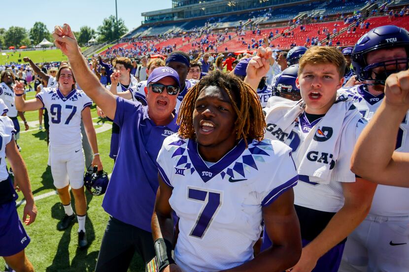 TCU head coach Sonny Dykes, left, celebrates with his players after a victory over SMU in an...