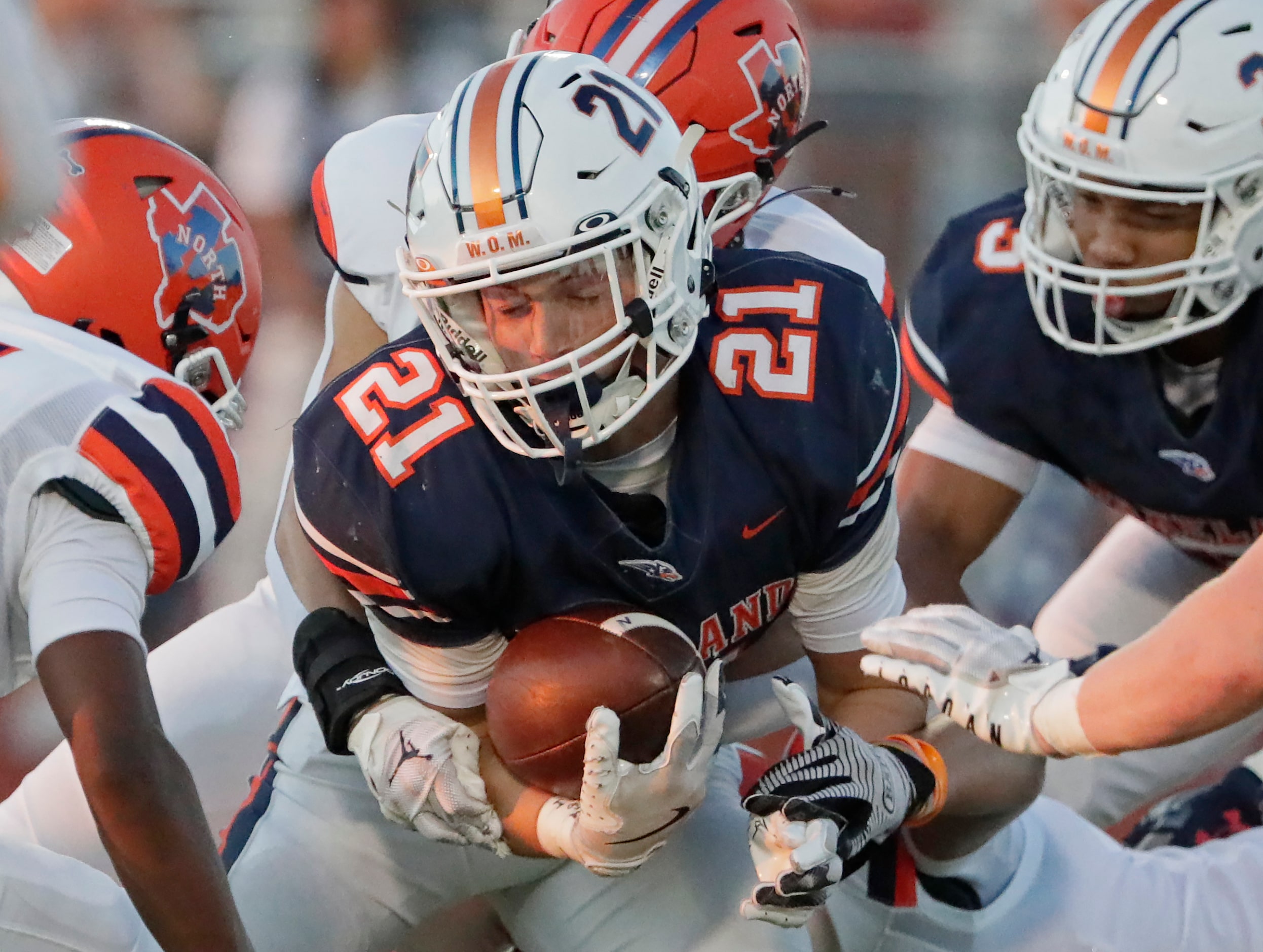 Wakeland High School running back Noah Conerly (21) is wrapped up by the defense during the...