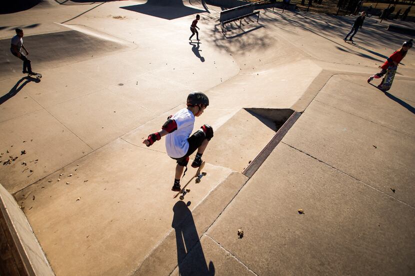 Travis Haley, 9, rides his skateboard at Lively Pointe Skate Park in Irving in this file...