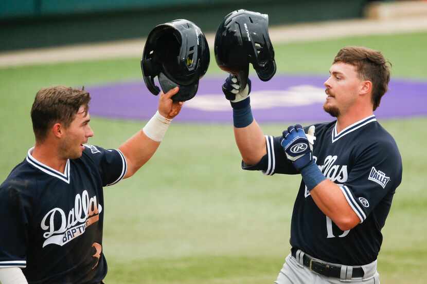 DBU's Cole Moore, right, is congratulated by Jackson Glenn (3) after hitting a two-run home...