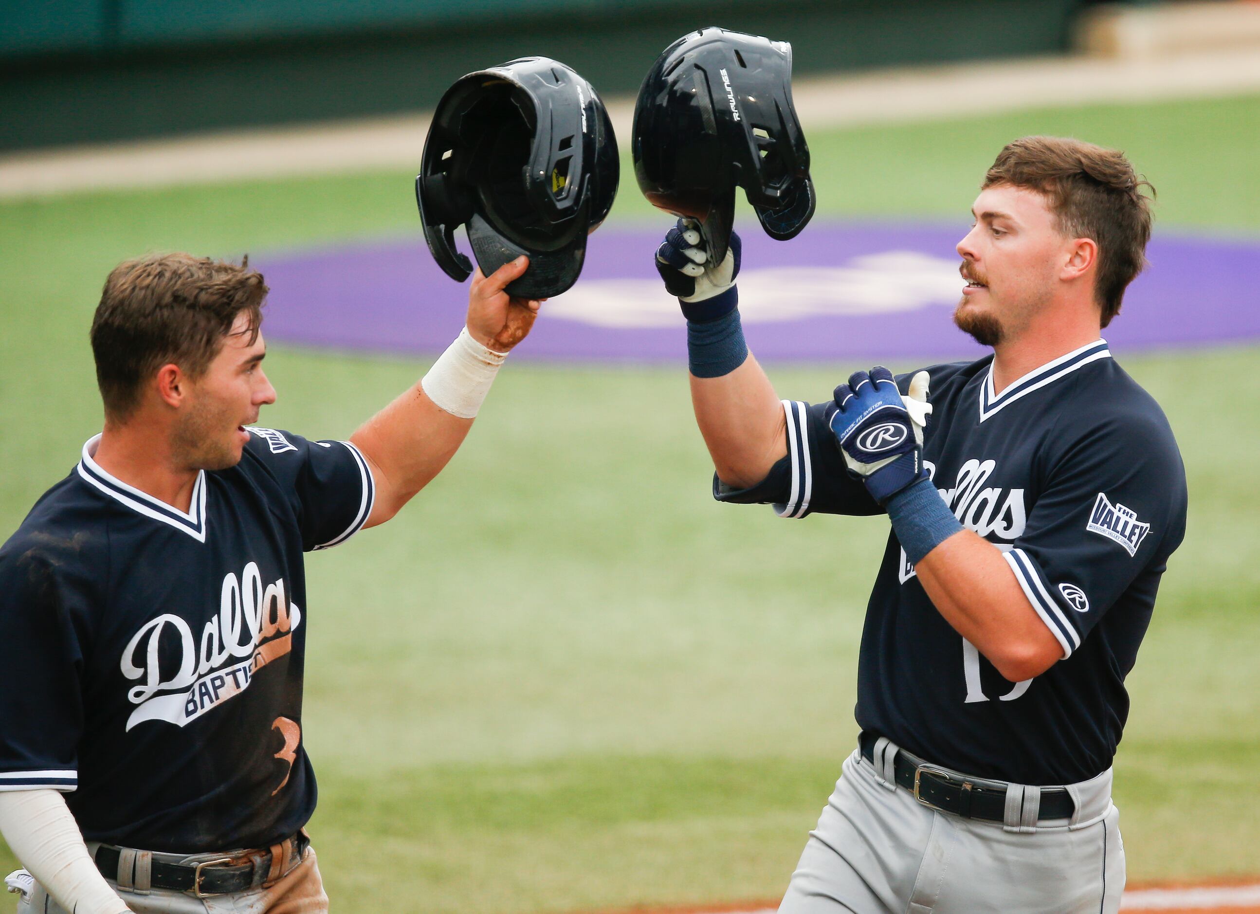 DBU Cole Moore, right, is congratulated by Jackson Glenn (3) after hitting a two-run home...