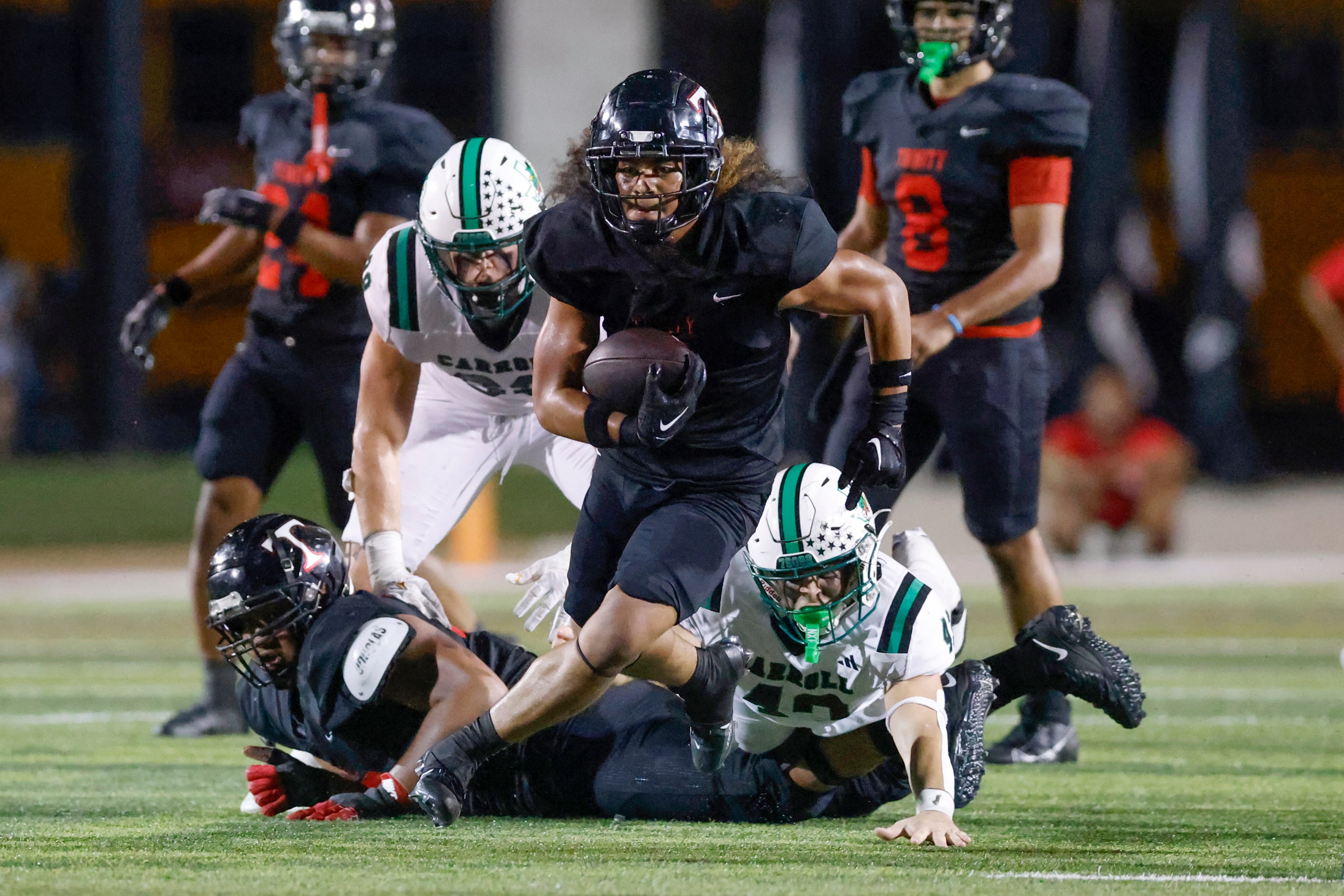 Euless Trinity running back Michael Saafi (6) rushes up the field during the second half of...