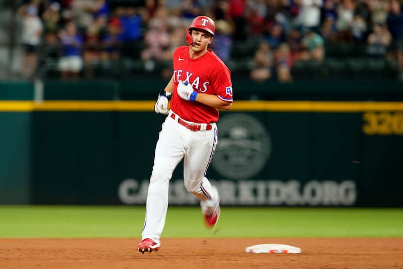 Texas Rangers' Corey Seager runs the bases after hitting a solo home run off Seattle...